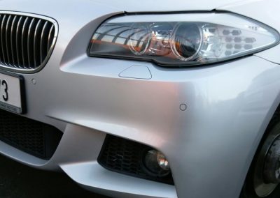 Image of a BMW car with a repaired bumper scuff