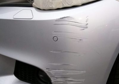 Image of a BMW car with a bumper scuff